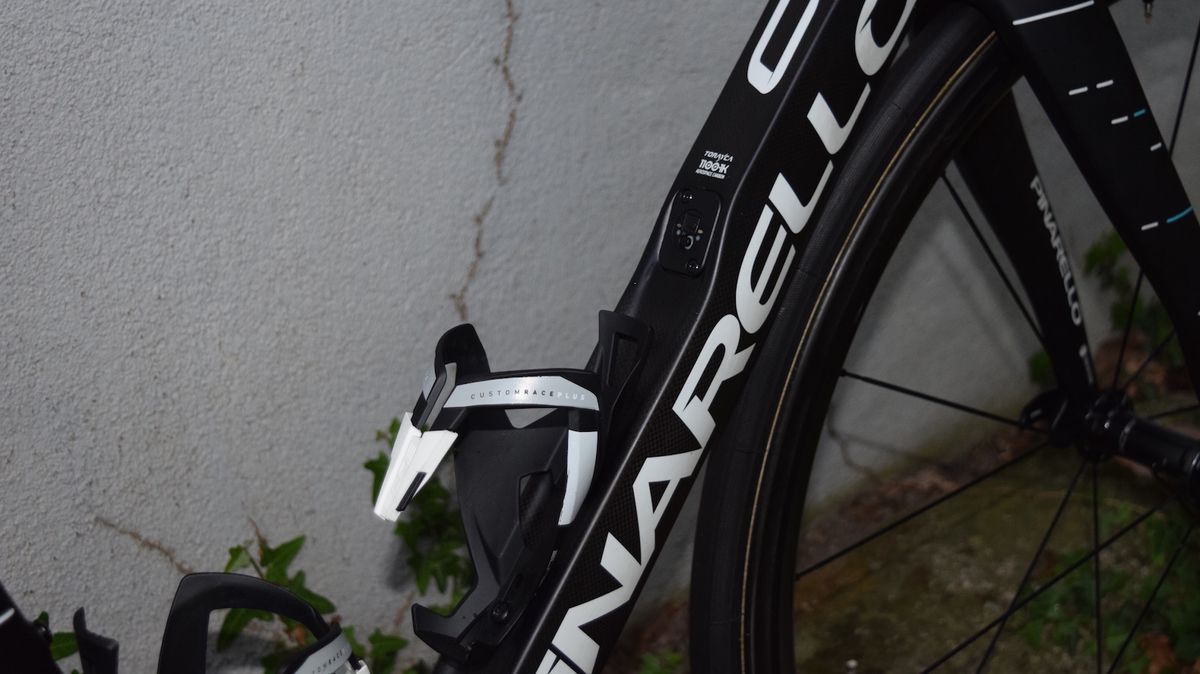The Pinarello Dogma F10 features a concave downtube, which allows the bottle cage to protrude from the frame less