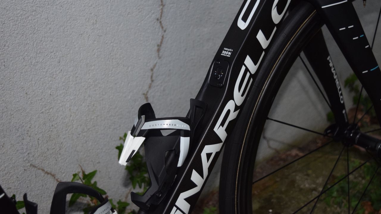 The Pinarello Dogma F10 features a concave downtube, which allows the bottle cage to protrude from the frame less