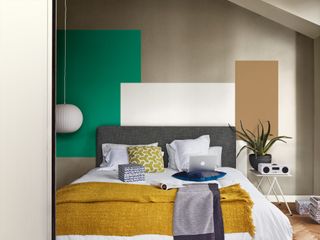 bedroom with colourful squares painted above the headboard