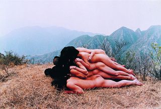 Naked people lying on top of each other to "make the mountain higher"
