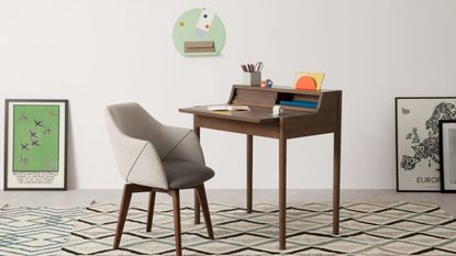 MADE Leonie wooden desk on geometric rug with grey fabric chair, wall art and grey walls