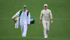 Harry Diamond and Rory McIlroy walk up the fairway