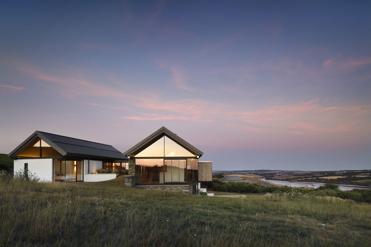 exterior of self build at dusk with lots of glazing