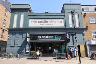 Blue-green outside of a building with a Spar shop on the ground floor and a cinema on the upper level