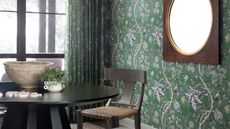 a small dining room with wallpapered walls
