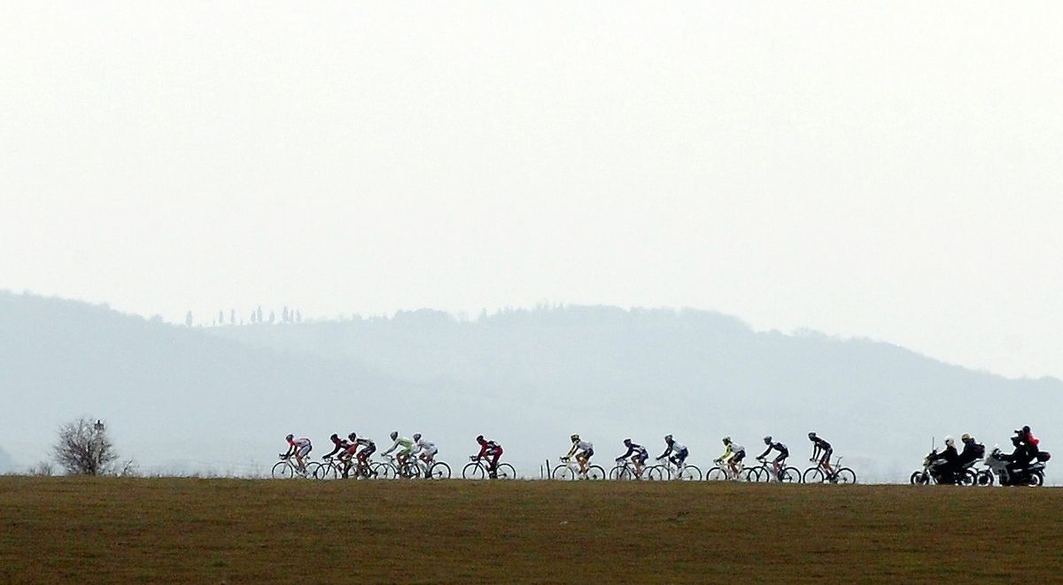 The peloton rides through the Tuscan countryside