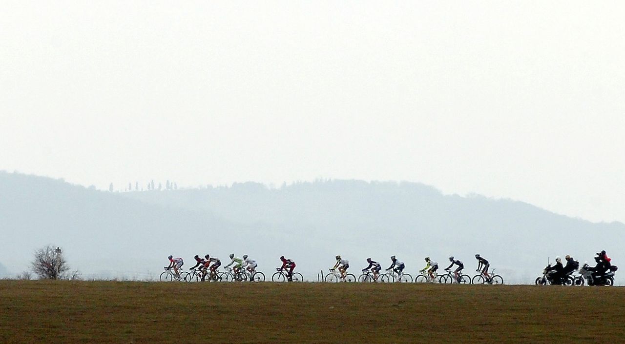 The peloton rides through the Tuscan countryside