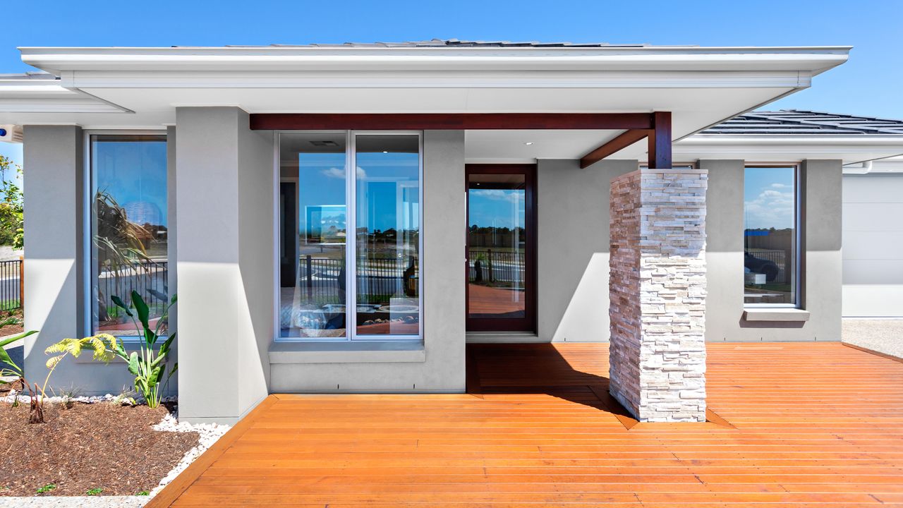 Front of a modern home with wooden yard