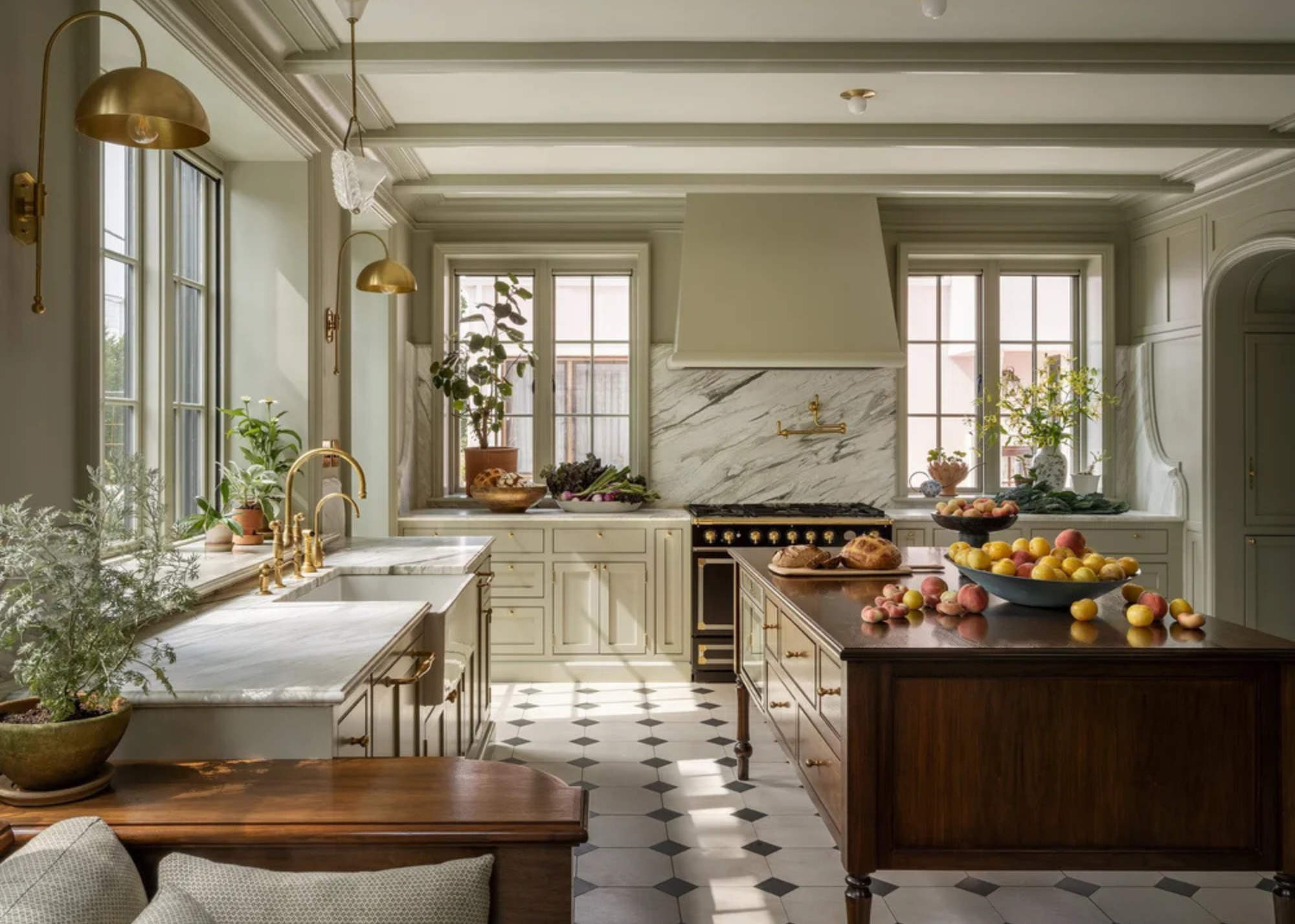big traditional kitchen with large butcher block island and soft, neutral toned cabinets