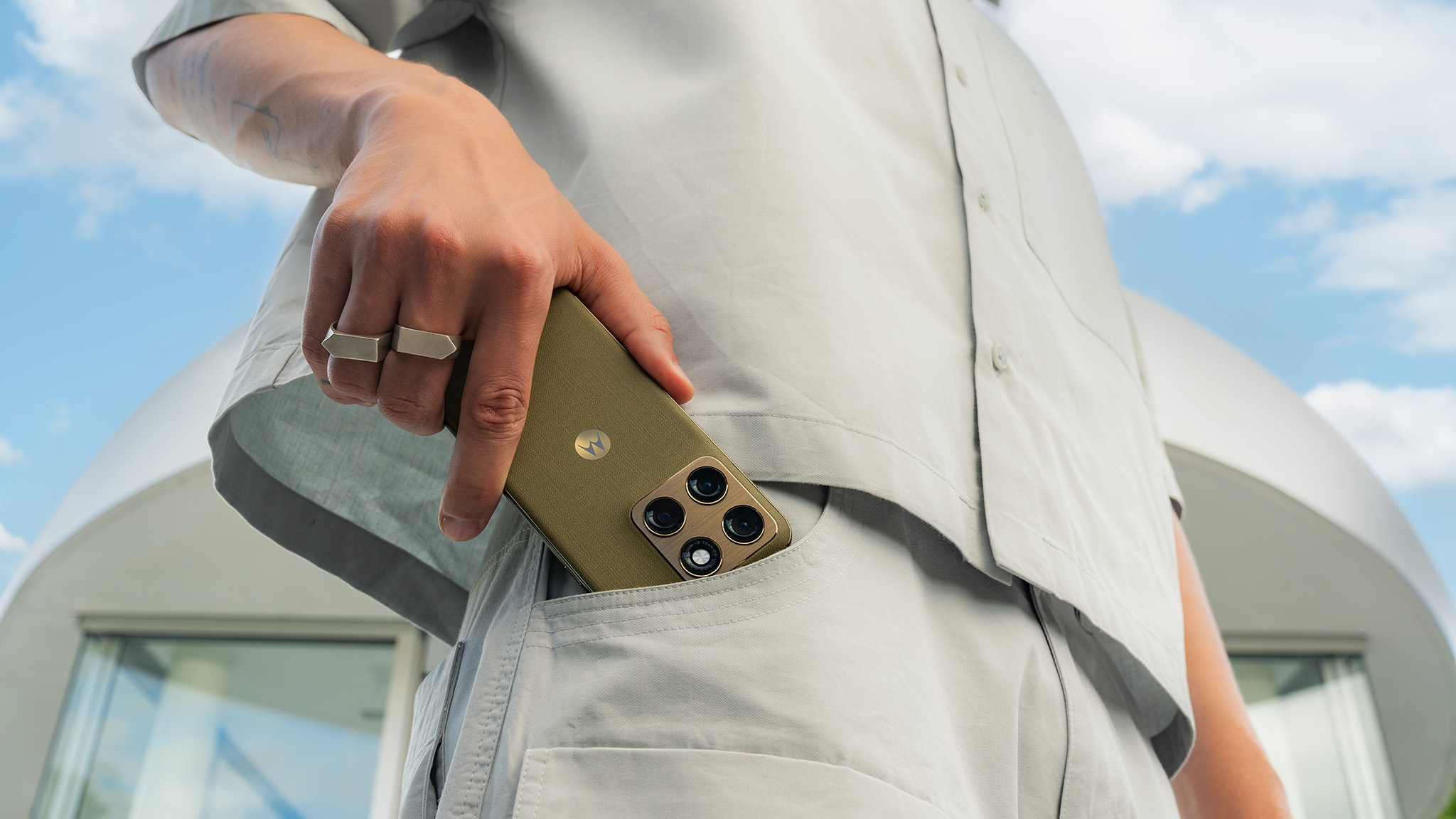 An official lifestyle image of someone holding the green Motorola Edge 2026