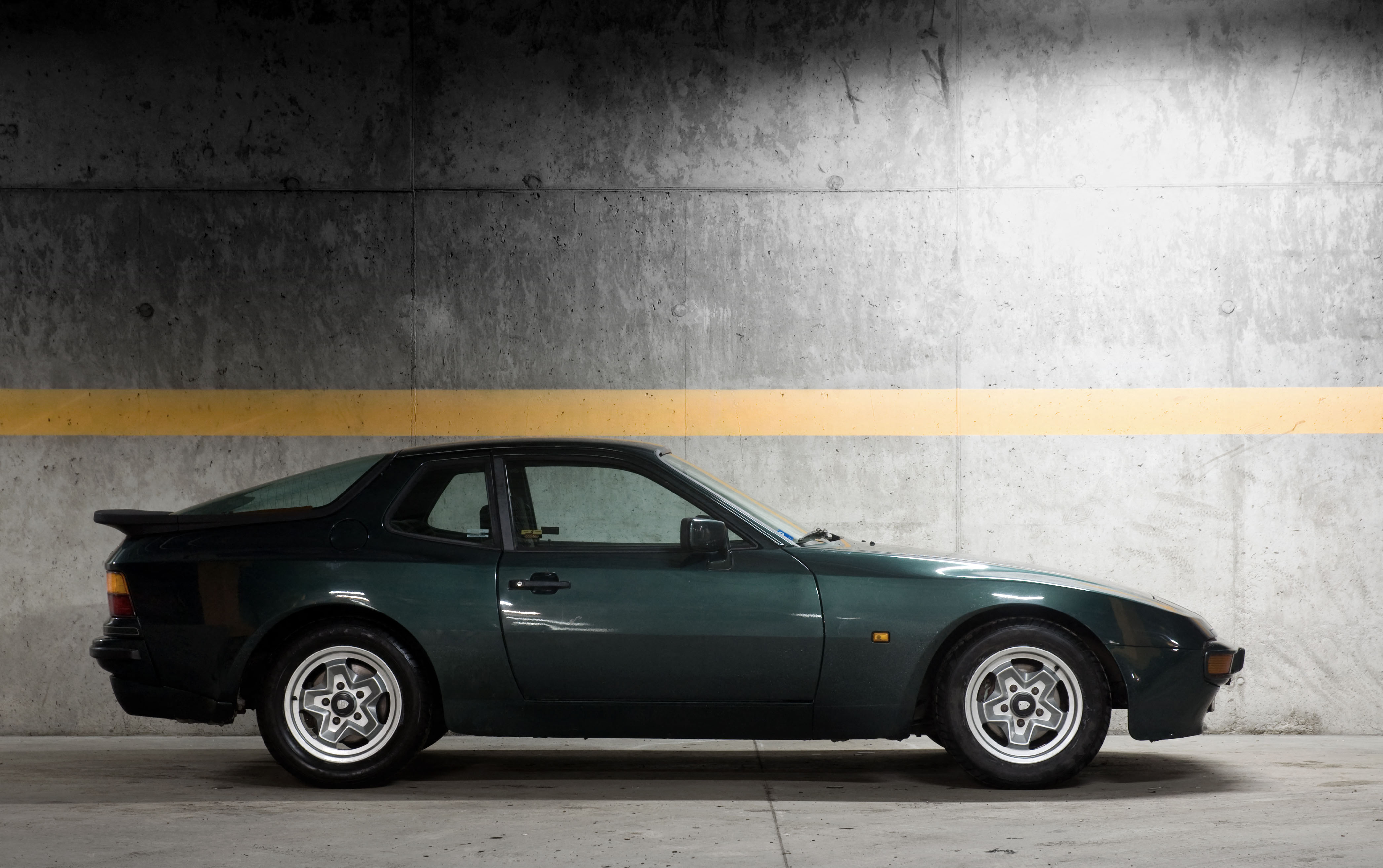 Side profile of a green porsche 944