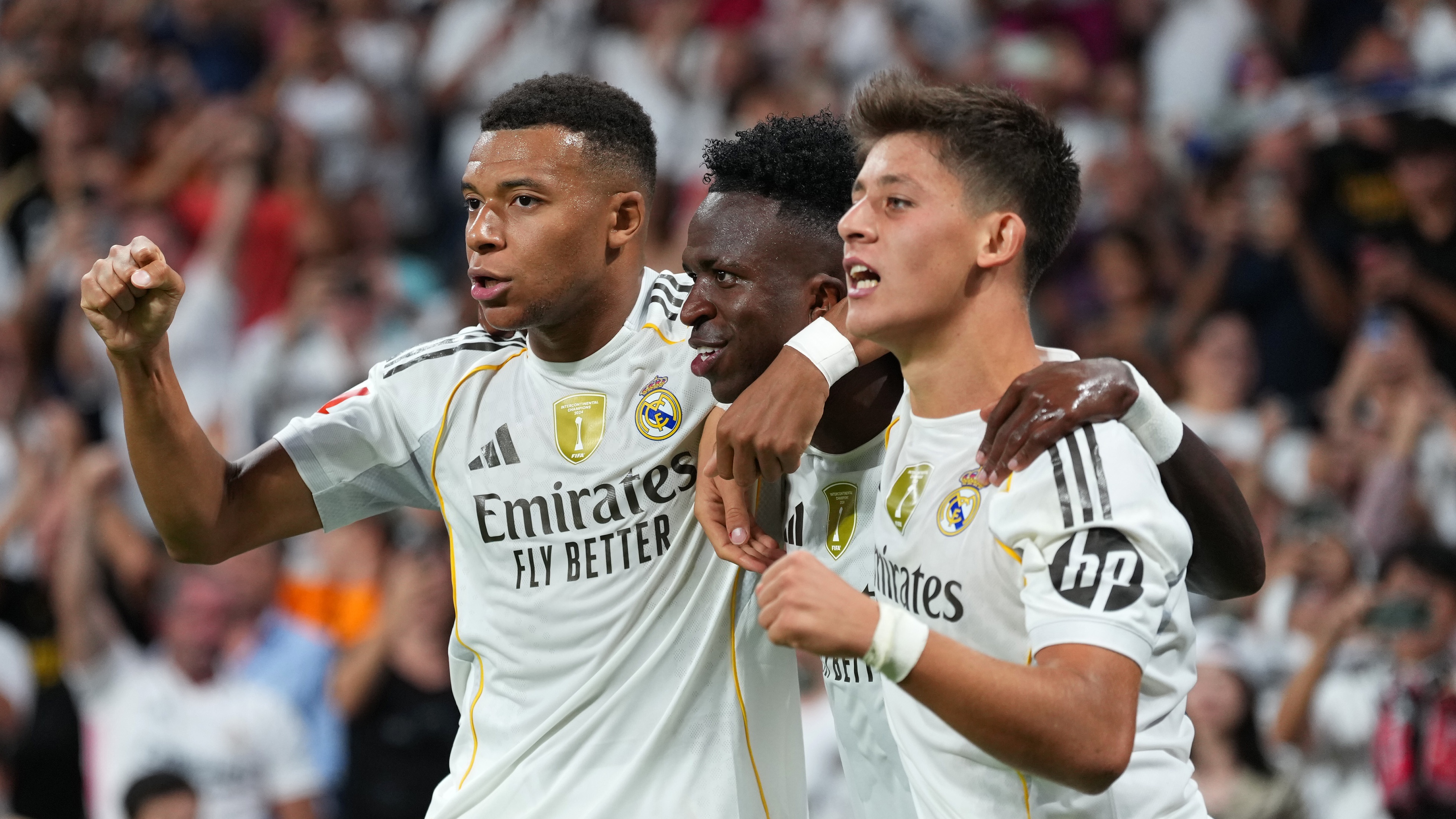 Vinicius Junior of Real Madrid celebrates scoring his team's second goal with teammates Kylian Mbappe and Arda Gueler during the LaLiga EA Sports match between Real Madrid CF and RCD Mallorca at Estadio Santiago Bernabeu on August 30, 2025 in Madrid, Spain.