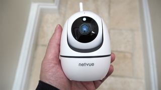 NetVue Orb Mini Home Security Camera held in a hand