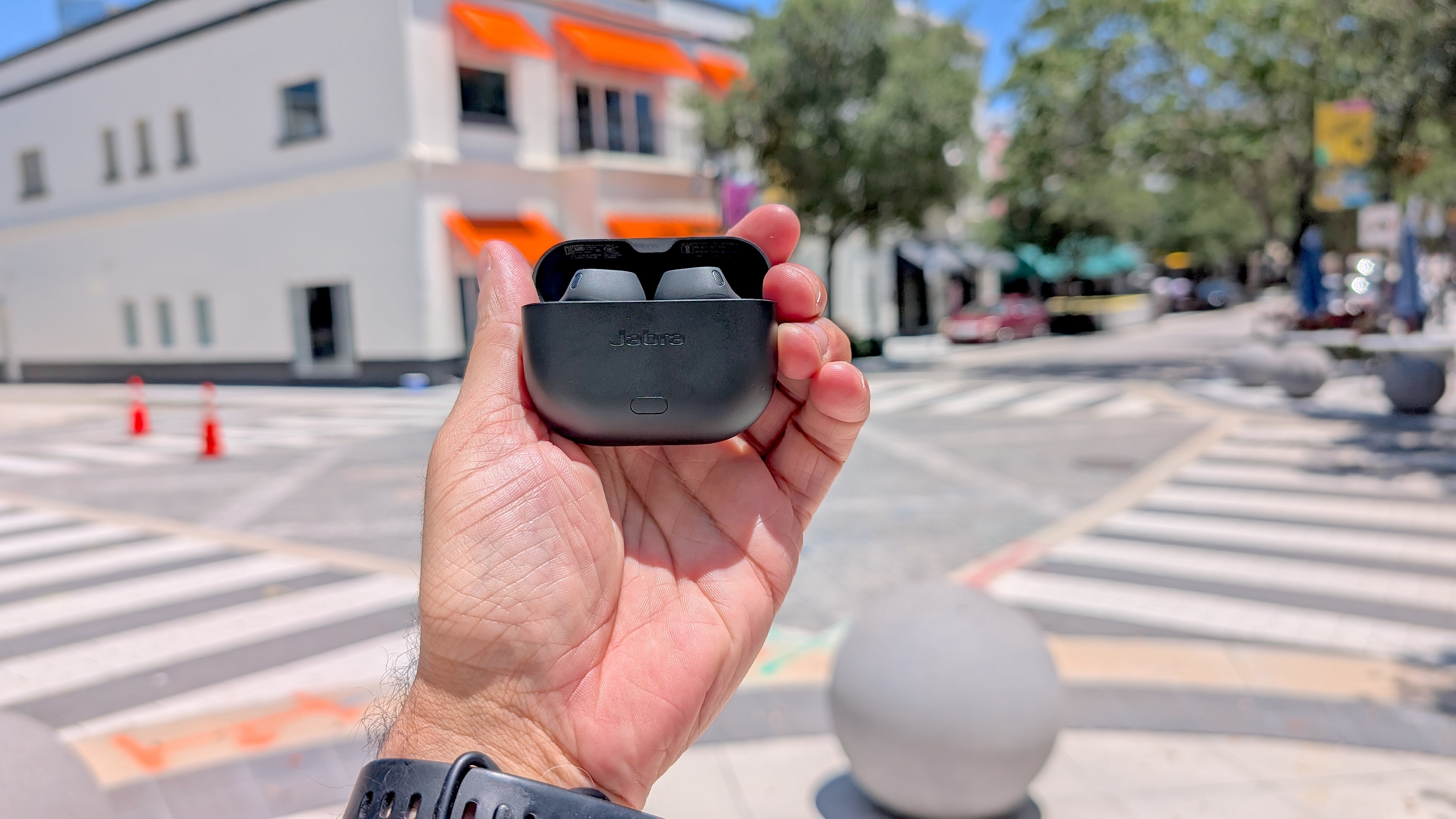 Our reviewer holding the Jabra Elite 8 Active Gen 2 in hand