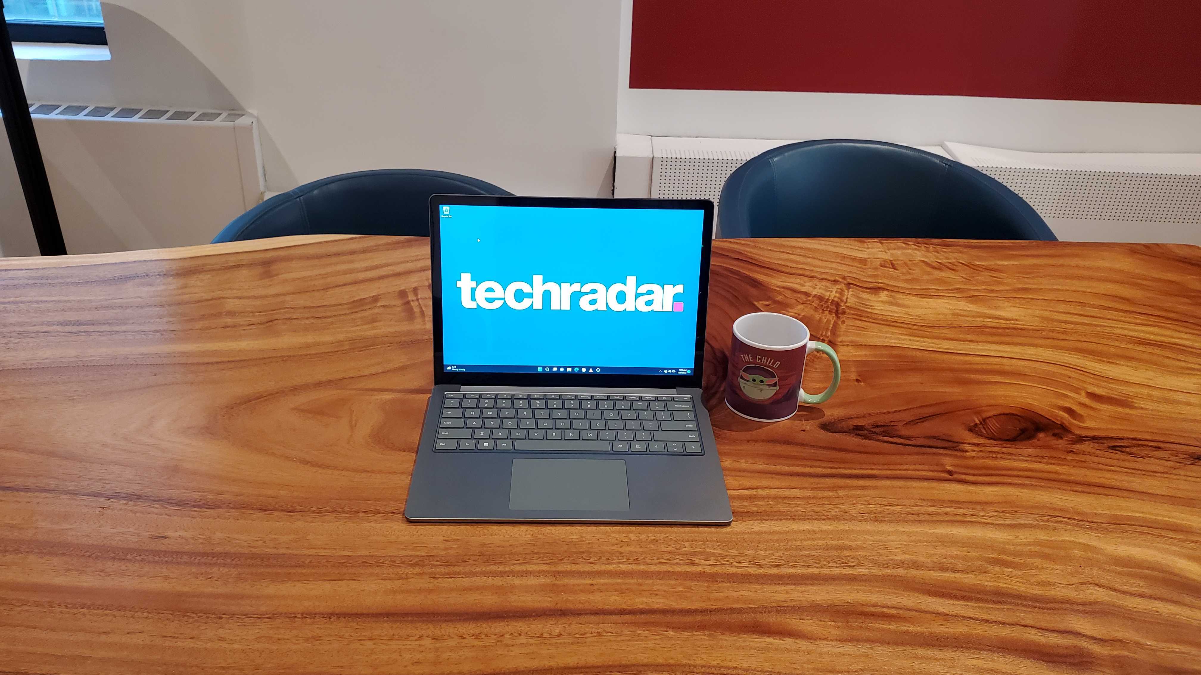 silver laptop sitting on wooden table