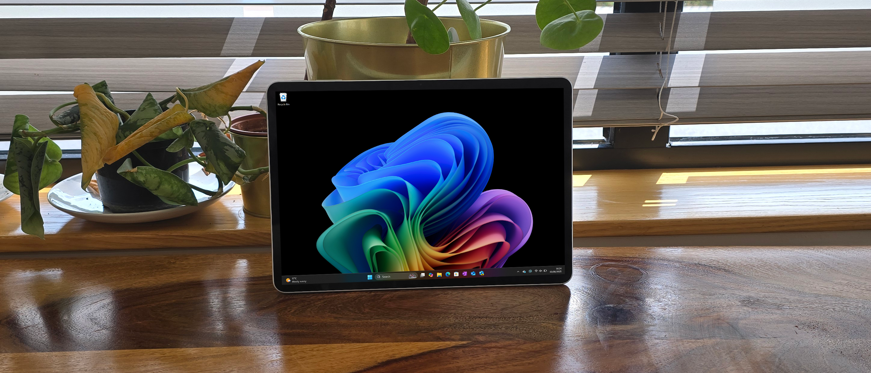 Microsoft Surface Pro 12 tablet on wooden table in relaxed cafe