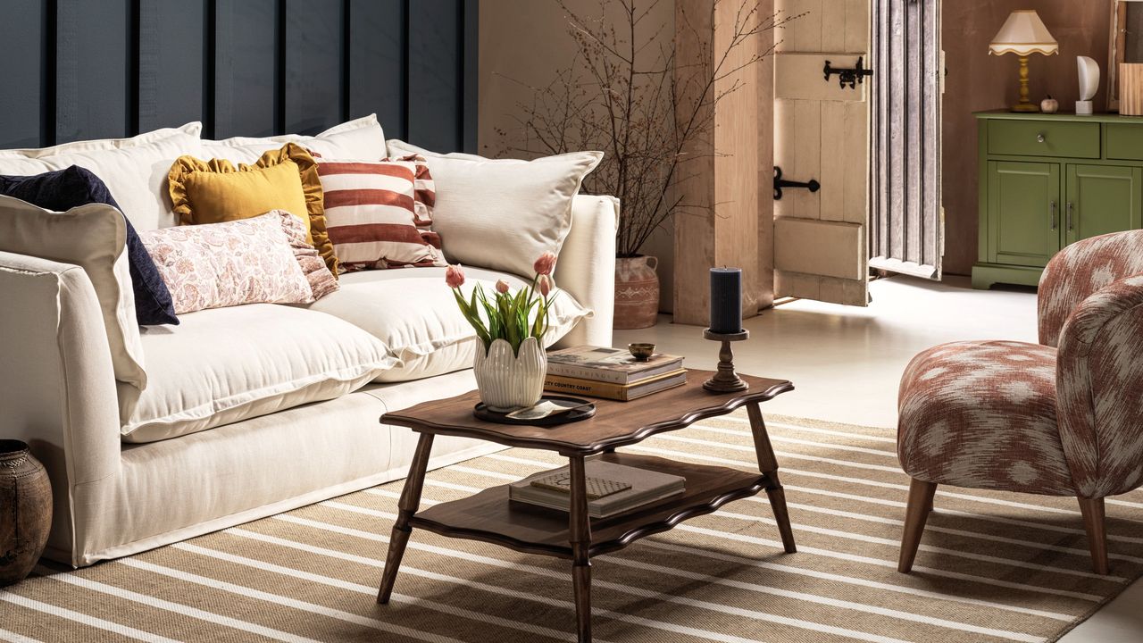 A living room with a cream sofa and tulips on a coffee table in a scalloped pot