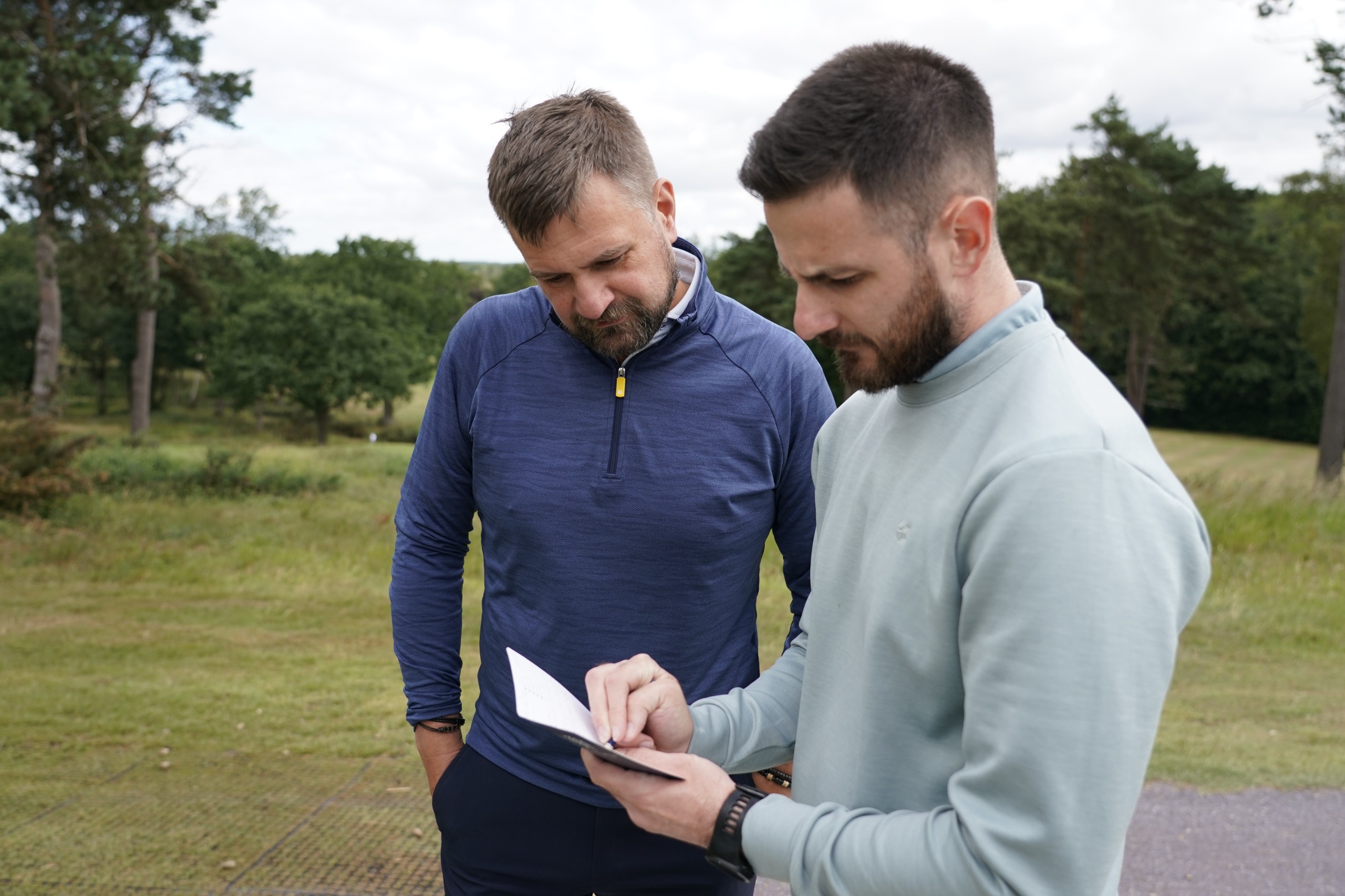 Baz Plummer marking a scorecard and working out how many shots he gets with his playing partner