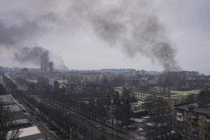 Smoke rises over Mariupol, where a Russian strike hit a maternity hospital