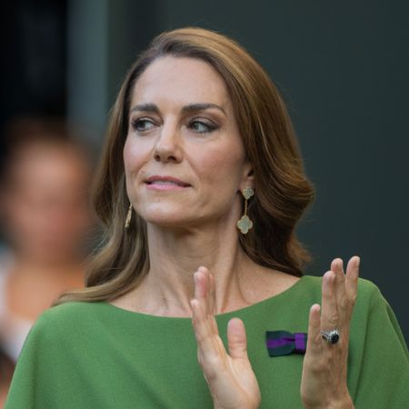 Princess Kate wears a green dress and has long brown hair with blonde highlights while applauding at Wimbledon 2026