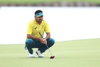 Jason Day lines up a putt at the Olympics