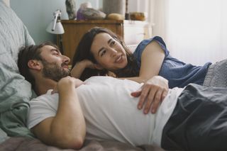 How to talk about a fetish: Couple relaxing and talking on bed