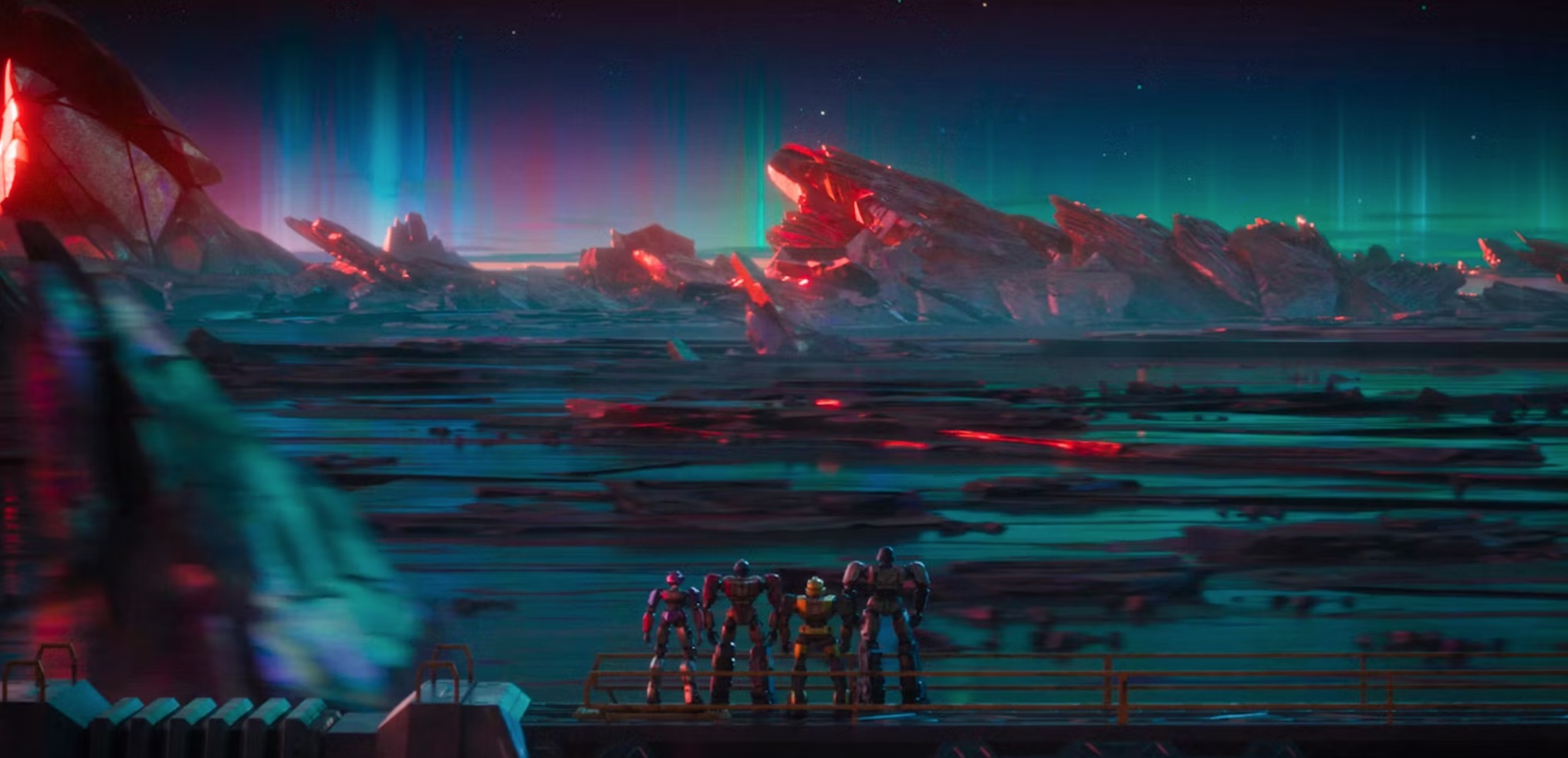 Auroras flash across the sky as four humanoid robots watch an alien sunset