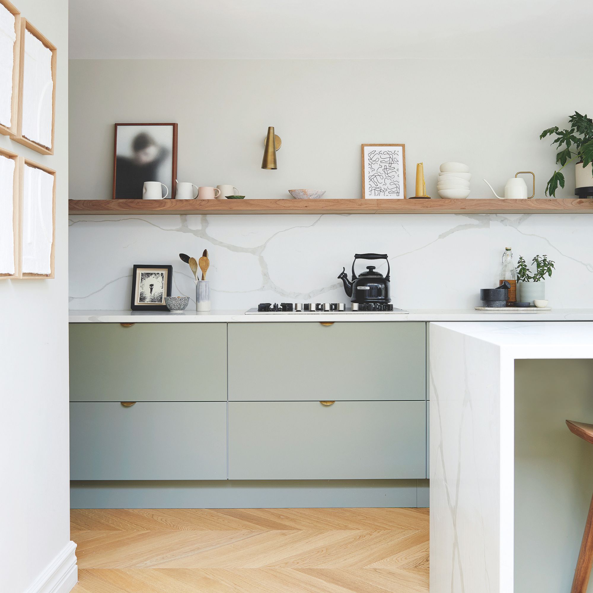 White kitchen with light green cabinets and wooden floor