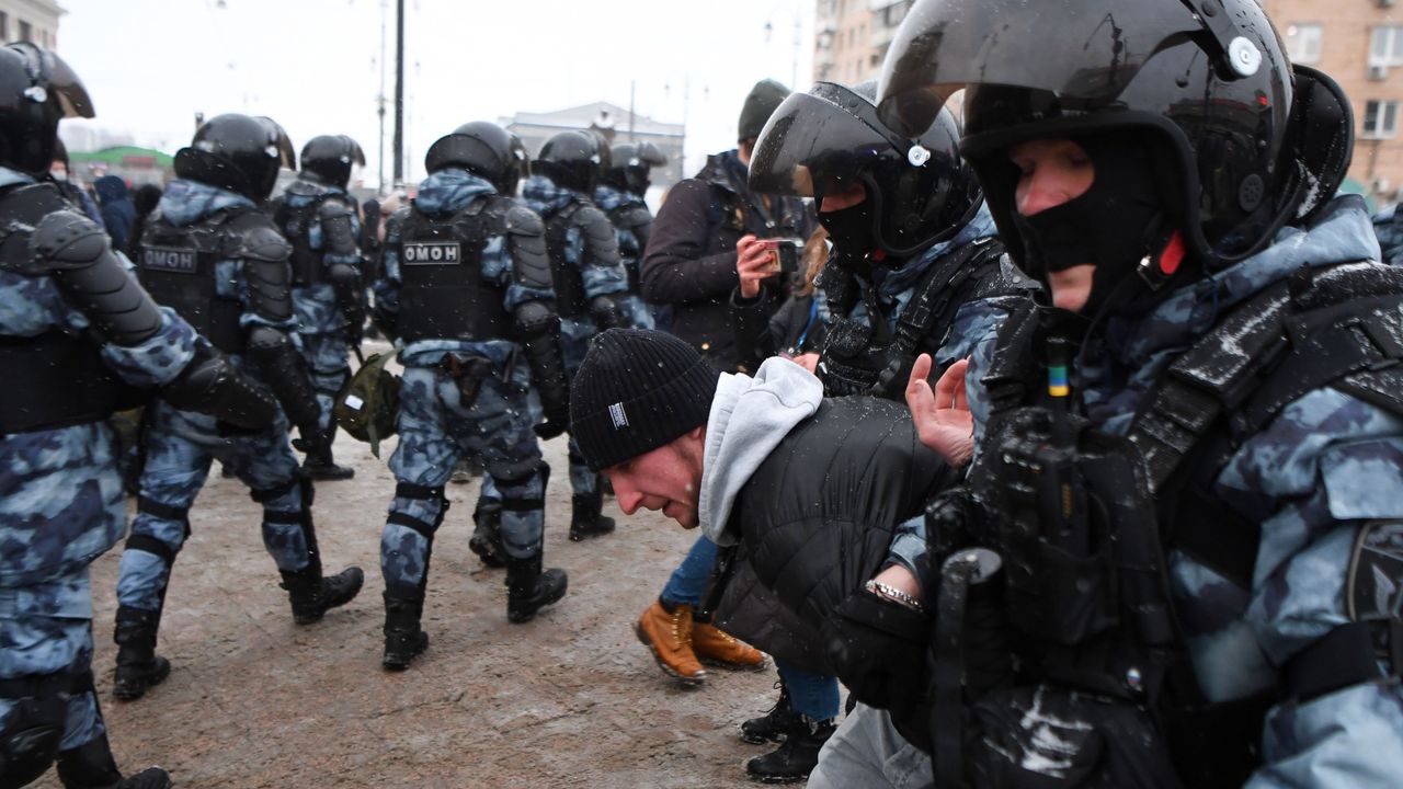 Riot police detain a man during a rally in support of jailed opposition leader Alexei Navalny