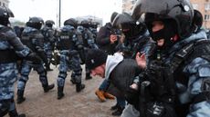 Riot police detain a man during a rally in support of jailed opposition leader Alexei Navalny