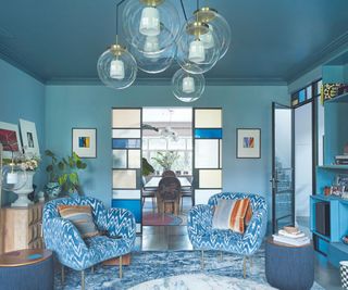 Blue room, rug, chairs, glass doors and lights