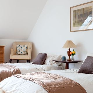 guest bedroom with white walls and bed with pillows