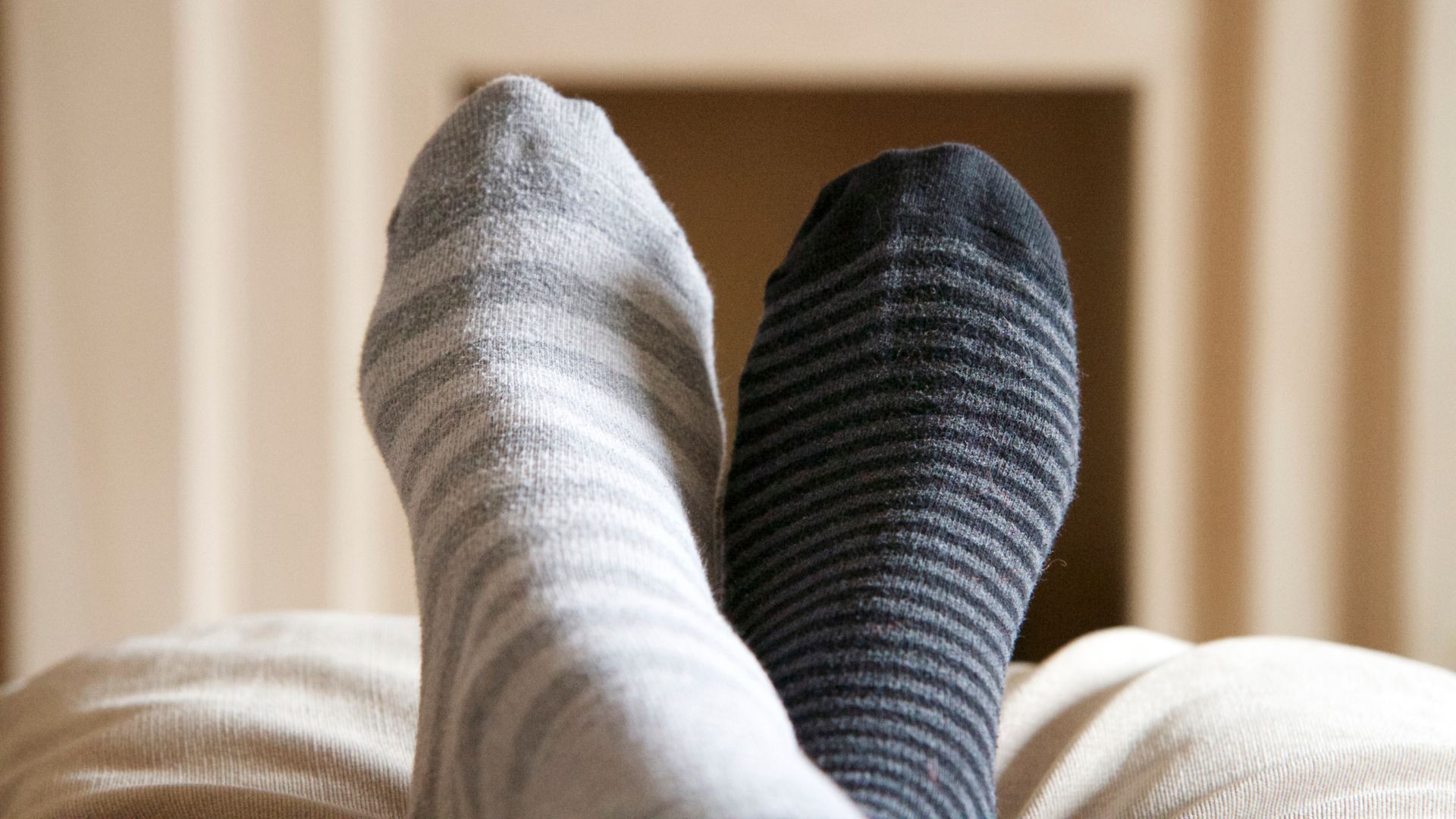 Feet wearing odd socks elevated for a relaxing afternoon nap