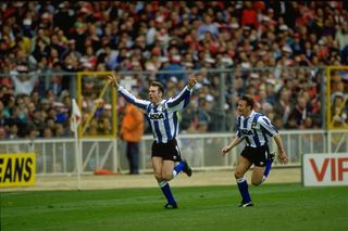 1991: John Sheridan (left) of Sheffield Wednesday celebrates after scoring the winning goal during the Rumbelows Cup Final against Manchester United at Wembley Stadium in London. Sheffield Wednesday won the match 1-0. \ Mandatory Credit: David Cannon/Allsport