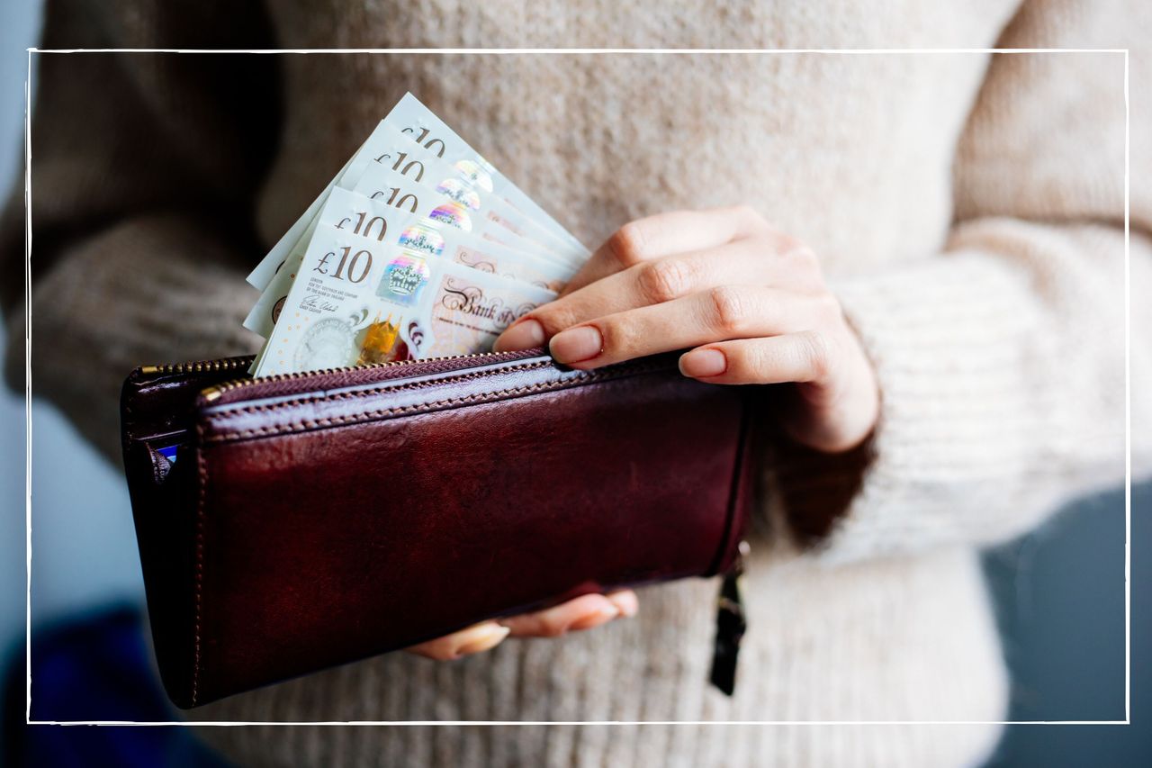 Close up of woman putting £10 notes into her purse