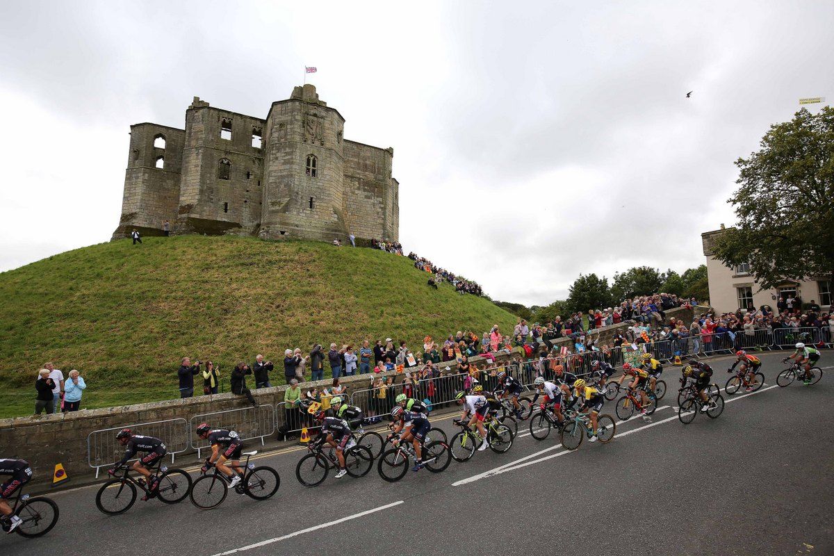 The peloton makes it way past a castle in Edinburgh
