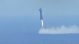 A SpaceX Starship Flight 6 Ship hovers over the Indian Ocean, kicking up a plume during splashdown