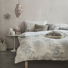 bedroom with white wall and bed with pillows