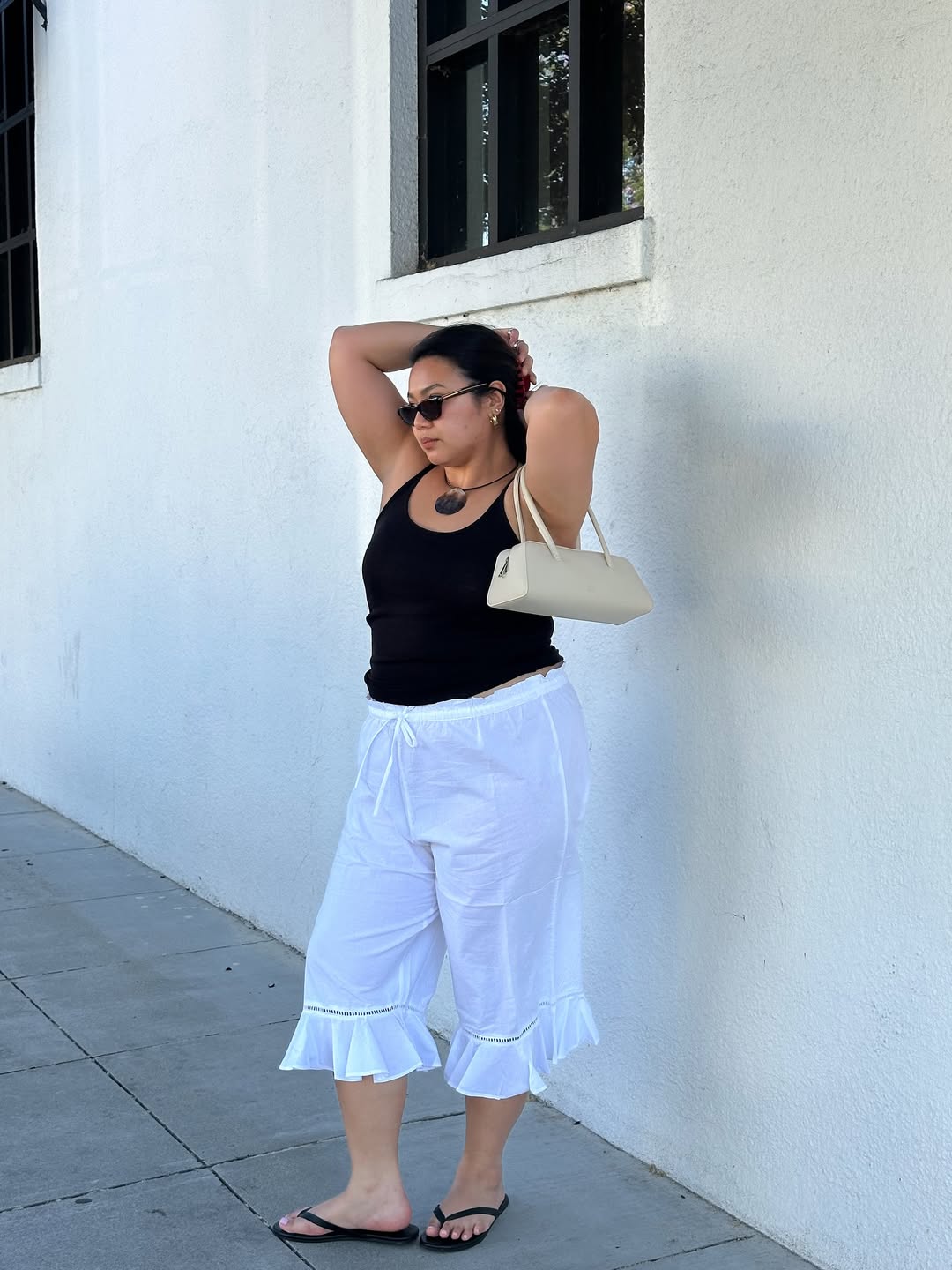 Marina in white bloomer trousers and black vest