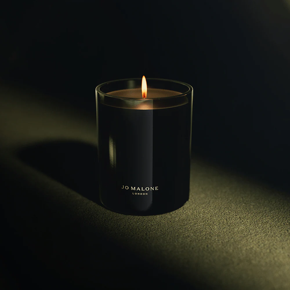 black glass candle on dark background