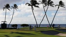 A golfer holes a putt at Waialae Country Club