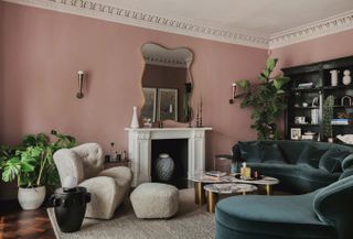 A living room with a moody pink tone