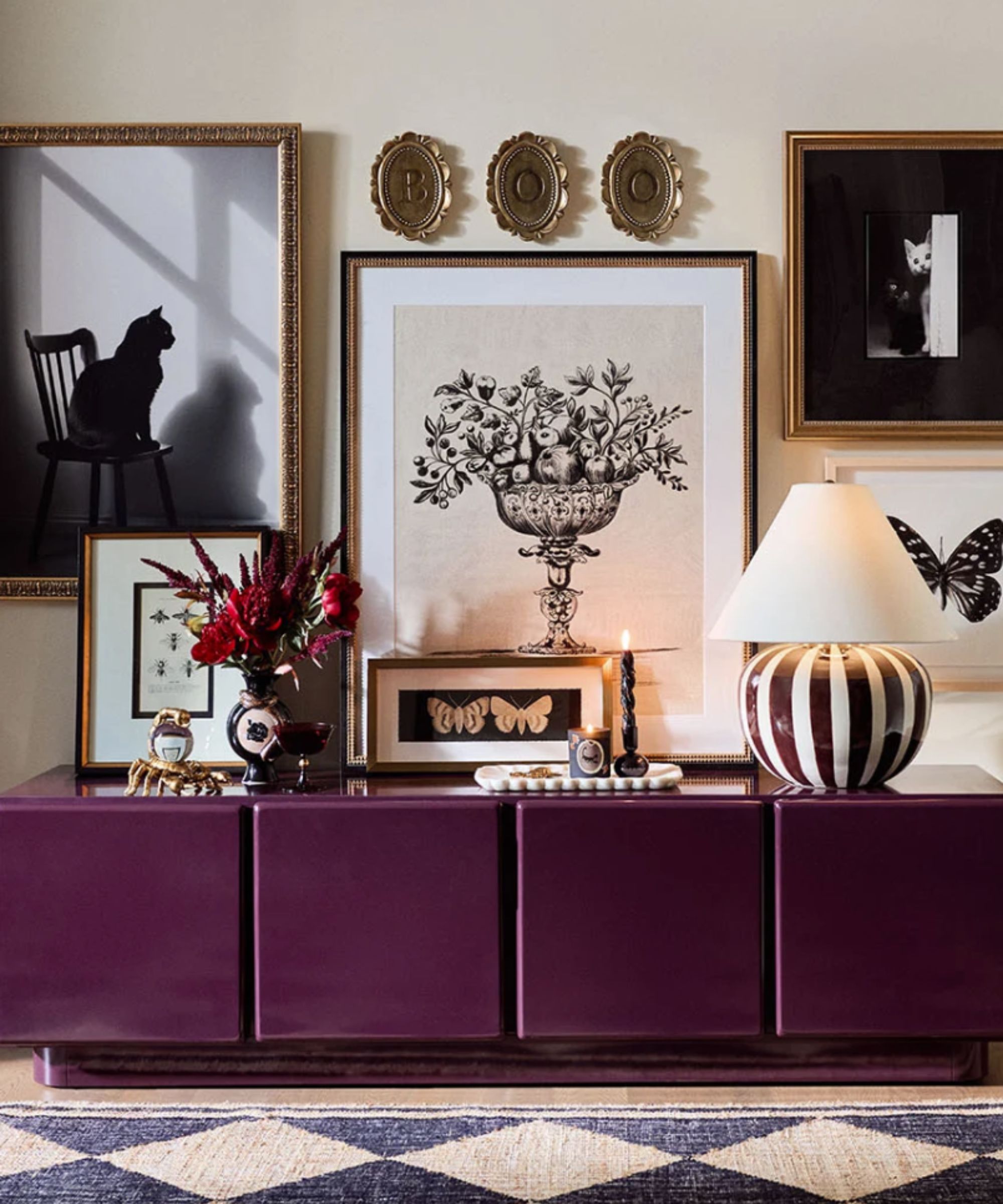 Gothic decor with monochrome prints and accessories and purple sideboard