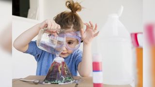 A little girl makes a volcano with an educational science kit. Live Science has rounded up the best Black Friday science kit deals for you.
