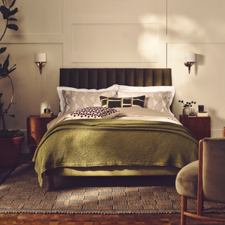 Bedroom with double bed and matching wall lights on either side of the bed