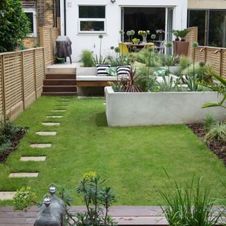 Back garden with flower beds a seating area