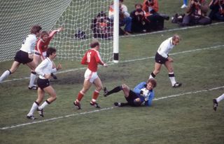 West Germany goalkeeper Sepp Maier makes a save at the feet of Poland's Grzegorz Lato at the 1974 World Cup.