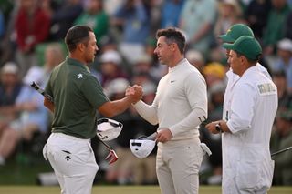 Xander Schauffele and Rory McIlroy shake hands on the 18th green at The Masters