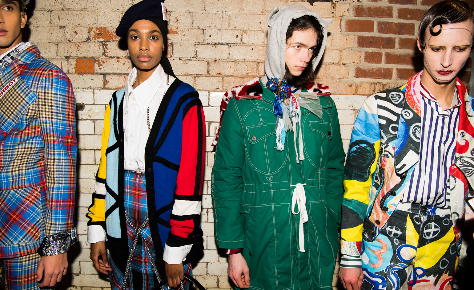 Four male models wearing clothing by Charles Jeffrey.