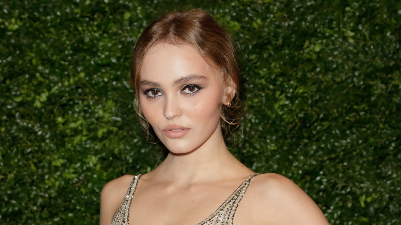 Lily-Rose Depp with a smoky eye and low bun hairstyle